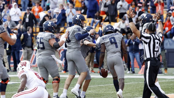 CHAMPAIGN, IL – OCTOBER 19: Josh Imatorbhebhe #9 of the Illinois Fighting Illini celebrates with teammates after making a 29-yard touchdown reception in the fourth quarter of the game against the Wisconsin Badgers at Memorial Stadium on October 19, 2019 in Champaign, Illinois. Illinois defeated Wisconsin 24-23. (Photo by Joe Robbins/Getty Images)
