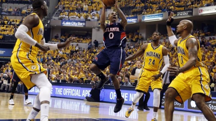 Apr 19, 2014; Indianapolis, IN, USA; Atlanta Hawks guard Jeff Teague (0) takes a shot against Indiana Pacers center Roy Hibbert (55) and forward David West (21) in game one during the first round of the 2014 NBA Playoffs at Bankers Life Fieldhouse. Mandatory Credit: Brian Spurlock-USA TODAY Sports