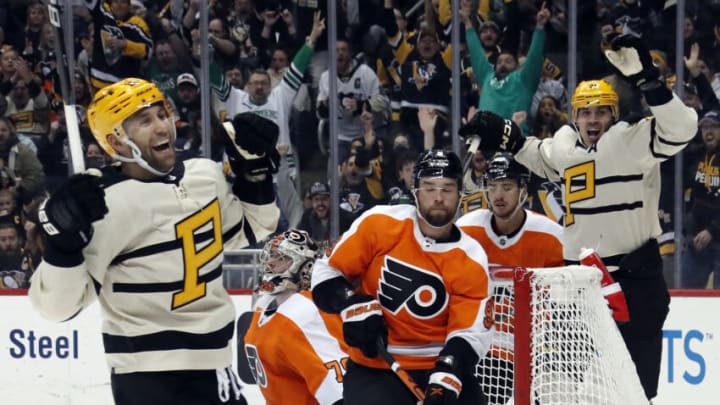 Mar 11, 2023; Pittsburgh, Pennsylvania, USA; Pittsburgh Penguins left wing Jason Zucker (left) reacts after scoring a goal against the Philadelphia Flyers during the third period at PPG Paints Arena. Pittsburgh won 5-1. Mandatory Credit: Charles LeClaire-USA TODAY Sports