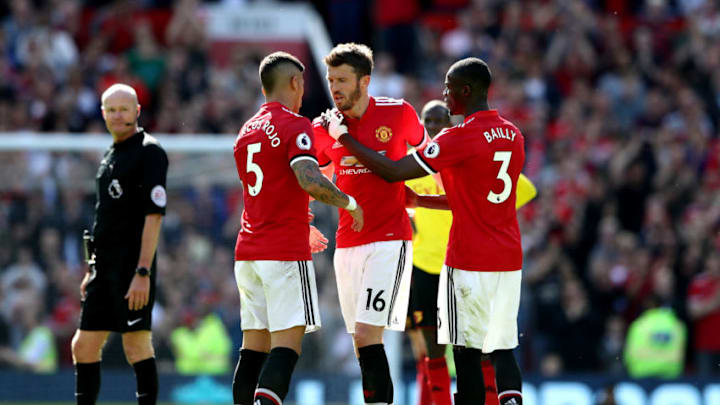 MANCHESTER, ENGLAND - MAY 13: Michael Carrick of Manchester United is embraced by Marcos Rojo of Manchester Uniated and Eric Bailly of Manchester Uniteda as he is susituted during the Premier League match between Manchester United and Watford at Old Trafford on May 13, 2018 in Manchester, England. (Photo by Matthew Lewis/Getty Images)