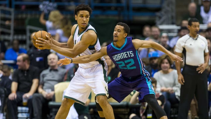 Apr 10, 2017; Milwaukee, WI, USA; Milwaukee Bucks guard Malcolm Brogdon (13) holds the ball away from Charlotte Hornets guard Brian Roberts (22) during the first quarter at BMO Harris Bradley Center. Mandatory Credit: Jeff Hanisch-USA TODAY Sports