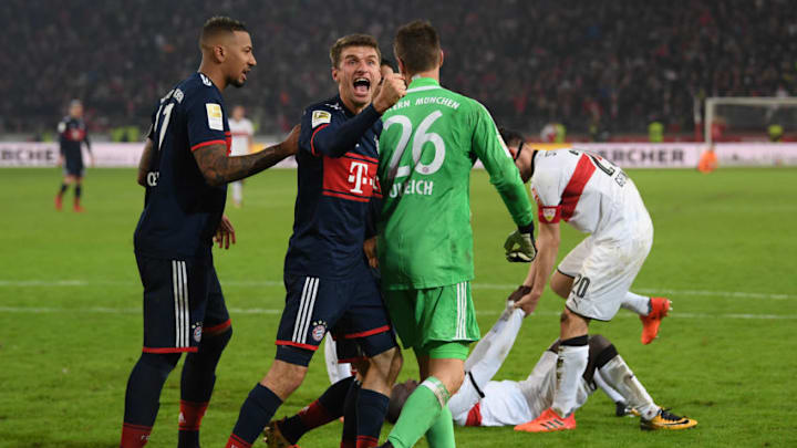STUTTGART, GERMANY - DECEMBER 16: Sven Ulreich of Bayern Muenchen is congratulated by Thomas Mueller of Bayern Muenchen after he saved a penalty against Chadrac Akolo of Stuttgart (back) during the Bundesliga match between VfB Stuttgart and FC Bayern Muenchen at Mercedes-Benz Arena on December 16, 2017 in Stuttgart, Germany. (Photo by Matthias Hangst/Bongarts/Getty Images)