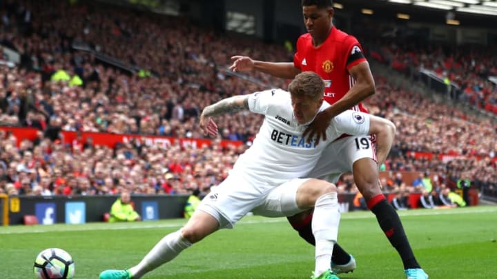 MANCHESTER, ENGLAND - APRIL 30: Alfie Mawson of Swansea City is put under pressure from Marcus Rashford of Manchester United during the Premier League match between Manchester United and Swansea City at Old Trafford on April 30, 2017 in Manchester, England. (Photo by Michael Steele/Getty Images)