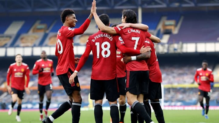 Manchester United's Uruguayan striker Edinson Cavani celebrates scoring his team's third goal with Manchester United's English striker Marcus Rashford during the English Premier League football match between Everton and Manchester United at Goodison Park in Liverpool, north west England on November 7, 2020. - Manchester United won the match 3-1. (Photo by Clive Brunskill / POOL / AFP) / RESTRICTED TO EDITORIAL USE. No use with unauthorized audio, video, data, fixture lists, club/league logos or 'live' services. Online in-match use limited to 120 images. An additional 40 images may be used in extra time. No video emulation. Social media in-match use limited to 120 images. An additional 40 images may be used in extra time. No use in betting publications, games or single club/league/player publications. / (Photo by CLIVE BRUNSKILL/POOL/AFP via Getty Images)