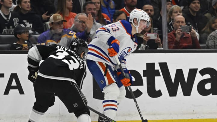 Apr 4, 2023; Los Angeles, California, USA; Edmonton Oilers center Ryan Nugent-Hopkins (93) keeps the puck from Los Angeles Kings right wing Viktor Arvidsson (33) in the second period at Crypto.com Arena. Mandatory Credit: Jayne Kamin-Oncea-USA TODAY Sports