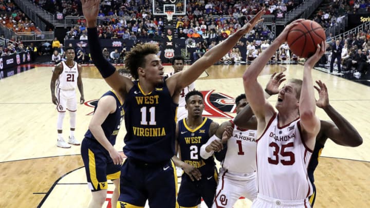 KANSAS CITY, MISSOURI - MARCH 13: Brady Manek #35 of the Oklahoma Sooners shoots as Emmitt Matthews Jr. #11 of the West Virginia Mountaineers defends during the first round game of the Big 12 Basketball Tournament at the Sprint Center on March 13, 2019 in Kansas City, Missouri. (Photo by Jamie Squire/Getty Images)