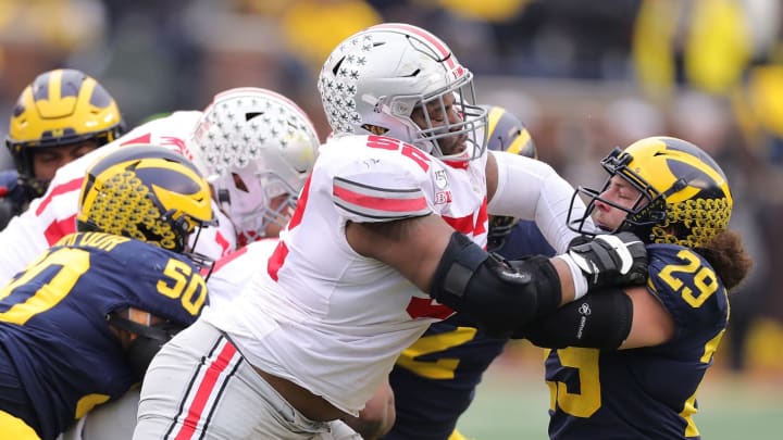 ANN ARBOR, MI – NOVEMBER 30: Wyatt Davis #52 of the Ohio State Buckeyes battles with Jordan Glasgow #29 of the Michigan Wolverines during the first quarter of the game at Michigan Stadium on November 30, 2019 in Ann Arbor, Michigan. Ohio State defeated Michigan 56-27. (Photo by Leon Halip/Getty Images)