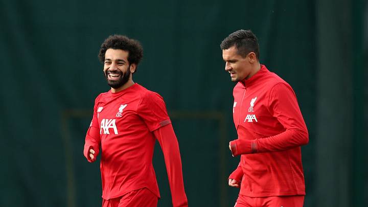 LIVERPOOL, ENGLAND - OCTOBER 22: Mohamed Salah share a joke with Dejan Lovren during a Liverpool training session ahead of the Champions League group E match against KRC Genk at Melwood Training Ground on October 22, 2019 in Liverpool, England. (Photo by Jan Kruger/Getty Images)