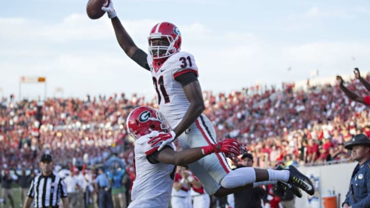 LITTLE ROCK, AR - OCTOBER 18: Chris Conley #31 of the Georgia Bulldogs is lifted in the air after scoring a touchdown against the Arkansas Razorbacks at War Memorial Stadium on October 18, 2014 in Little Rock, Arkansas. The Bulldogs defeated the Razorbacks 45-32. (Photo by Wesley Hitt/Getty Images)