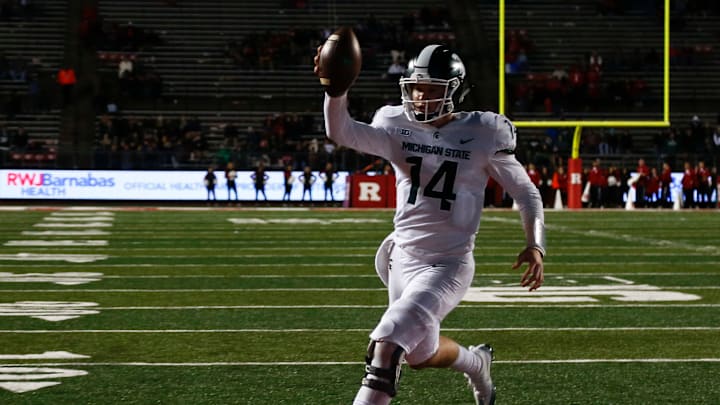 PISCATAWAY, NJ – NOVEMBER 25: Brian Lewerke #14 of the Michigan State Spartans runs in for a touchdown against the Rutgers Scarlet Knights during their game on November 25, 2017 in Piscataway, New Jersey. (Photo by Jeff Zelevansky/Getty Images)