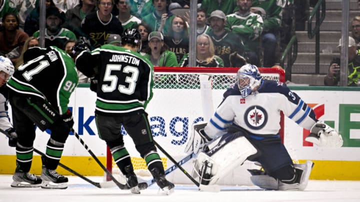 Nov 25, 2022; Dallas, Texas, USA; Winnipeg Jets goaltender Connor Hellebuyck (37) defends against Dallas Stars center Tyler Seguin (91) and center Wyatt Johnston (53) during the third period at the American Airlines Center. Mandatory Credit: Jerome Miron-USA TODAY Sports