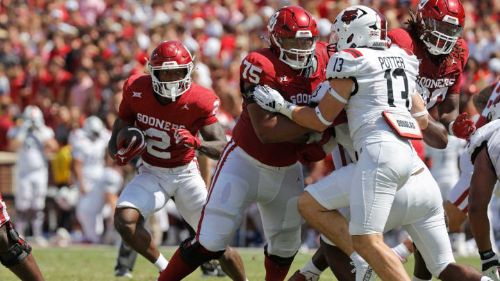 Oklahoma’s Jovantae Barnes (2) carries the ball as Walter Rouse (75) blocks Arkansas State’s Gavin Potter (13) during a college football game between the University of Oklahoma Sooners (OU) and the Arkansas State Red Wolves at Gaylord Family-Oklahoma Memorial Stadium in Norman, Okla., Saturday, Sept. 2, 2023. Oklahoma won 73-0.