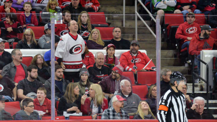 RALEIGH, NC - JANUARY 21: NHL referee Wes McCauley (4) gets berated by a fan during a game between the Vegas Golden Knights and the Carolina Hurricanes at the PNC Arena in Raleigh, NC on January 21, 2018. Vegas defeated Carolina 5-1. (Photo by Greg Thompson/Icon Sportswire via Getty Images)