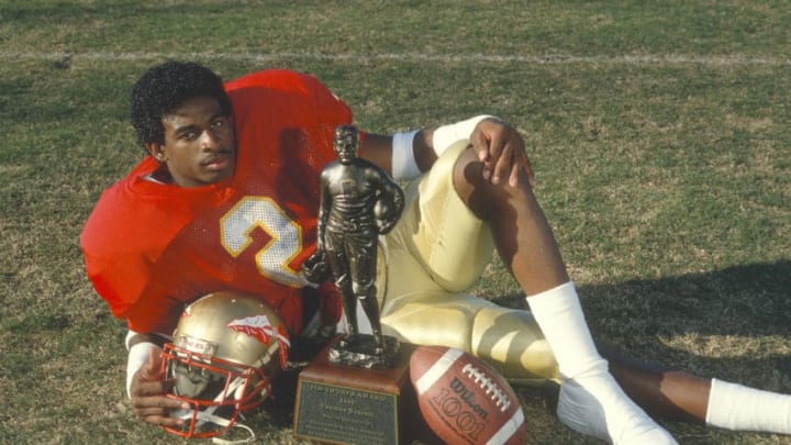 TALLAHASSEE, FL - CIRCA 1988: Defensive back Deion Sanders #2 of the Florida State Seminoles winner of the 1988 Jim Thorpe Award, poses with the trophy circa 1988 at Doak Campbell Stadium at Florida State University in Tallahassee, Florida. (Photo by Focus on Sport/Getty Images)