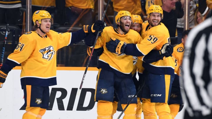 Nashville Predators center Luke Kunin (11) celebrates with teammates after scoring the game-winning goal in the second overtime against the Carolina Hurricanes in game four of the first round of the 2021 Stanley Cup Playoffs at Bridgestone Arena. Mandatory Credit: Christopher Hanewinckel-USA TODAY Sports