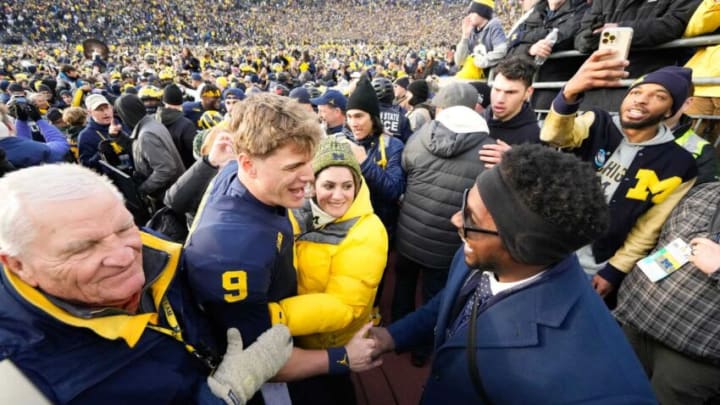 Nov 25, 2023; Ann Arbor, Michigan, USA; Michigan Wolverines quarterback J.J. McCarthy (9) shakes hands with Desmond Howard as he leaves the field following the NCAA football game against the Ohio State Buckeyes at Michigan Stadium. Ohio State lost 30-24.