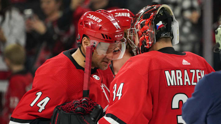 RALEIGH, NC - JANUARY 21: Carolina Hurricanes Right Wing Justin Williams (14) congratulates Carolina Hurricanes Goalie Petr Mrazek (34) after a game between the Carolina Hurricanes and the Winnipeg Jets on January 21, 2020 at the PNC Arena in Raleigh, NC. (Photo by Greg Thompson/Icon Sportswire via Getty Images)