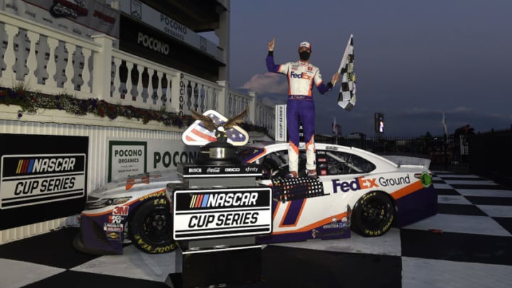 LONG POND, PENNSYLVANIA - JUNE 28: Denny Hamlin, driver of the #11 FedEx Ground Toyota, celebrates in victory lane after winning the NASCAR Cup Series Pocono 350 at Pocono Raceway on June 28, 2020 in Long Pond, Pennsylvania. (Photo by Jared C. Tilton/Getty Images)