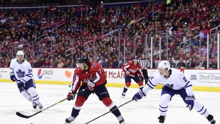 WASHINGTON, DC - OCTOBER 13: T.J. Oshie #77 of the Washington Capitals skates with the puck against Ron Hainsey #2 of the Toronto Maple Leafs in the first period at Capital One Arena on October 13, 2018 in Washington, DC. (Photo by Patrick McDermott/NHLI via Getty Images)