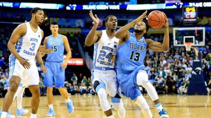 Nov 11, 2016; New Orleans, LA, USA; Tulane Green Wave guard Malik Morgan (13) drives past North Carolina Tar Heels guard Kenny Williams (24) during the first half of a game at the Smoothie King Center. Mandatory Credit: Derick E. Hingle-USA TODAY Sports