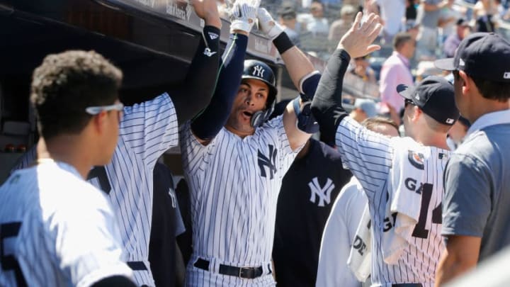 NEW YORK, NY - JUNE 16: Giancarlo Stanton #27 of the New York Yankees celebrates his fifth inning home run against the Tampa Bay Rays with his teammates in the dugout at Yankee Stadium on June 16, 2018 in the Bronx borough of New York City. (Photo by Jim McIsaac/Getty Images)