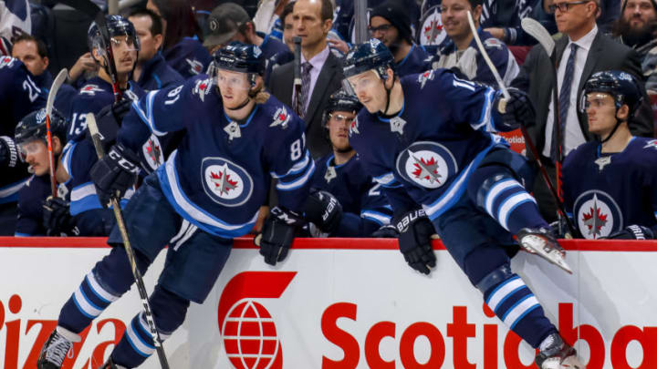 WINNIPEG, MB - NOVEMBER 14: Kyle Connor #81 and Bryan Little #18 of the Winnipeg Jets change on the fly during third period action against the Washington Capitals at the Bell MTS Place on November 14, 2018 in Winnipeg, Manitoba, Canada. The Jets defeated the Caps 3-1. (Photo by Jonathan Kozub/NHLI via Getty Images)