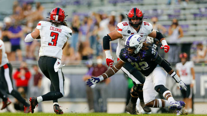 Nov 7, 2020; Fort Worth, Texas, USA; Texas Tech Red Raiders quarterback Henry Colombi (3) scrambles to get away from TCU Horned Frogs defensive end Ochaun Mathis (32) at Amon G. Carter Stadium. Mandatory Credit: Andrew Dieb-USA TODAY Sports