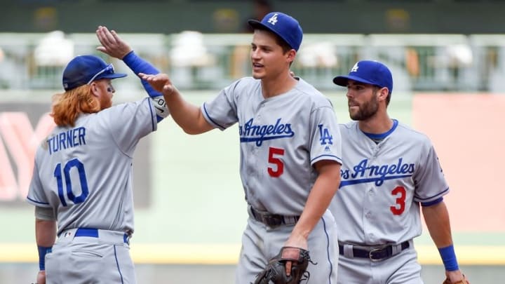 Jun 30, 2016; Milwaukee, WI, USA; Los Angeles Dodgers shortstop Corey Seager (5) celebrates with third baseman Justin Turner (10) after the Dodgers beat the Milwaukee Brewers 8-1 at Miller Park. Mandatory Credit: Benny Sieu-USA TODAY Sports