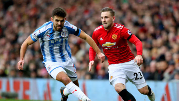 MANCHESTER, ENGLAND – FEBRUARY 03: Tommy Smith of Huddersfield Town and Luke Shaw of Manchester United battle for the ball during the Premier League match between Manchester United and Huddersfield Town at Old Trafford on February 3, 2018 in Manchester, England. (Photo by Mark Thompson/Getty Images)