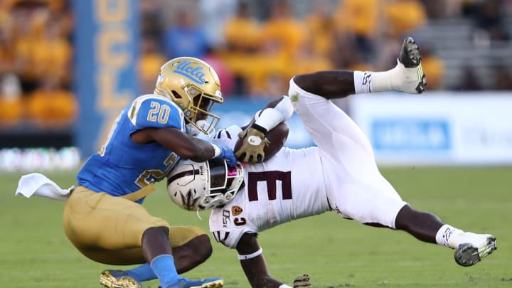 LOS ANGELES, CALIFORNIA – OCTOBER 26: Elisha Guidry #20 of the UCLA Bruins tackles Eno Benjamin #3 of the Arizona State Sun Devils during the first half of a game on October 26, 2019 in Los Angeles, California. (Photo by Sean M. Haffey/Getty Images)