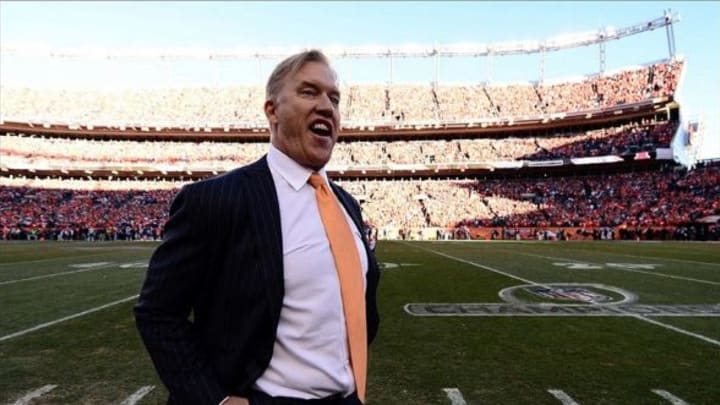 January 19, 2014; Denver, CO, USA; Denver Broncos executive vice president of football operations John Elway reacts late in the fourth quarter against the New England Patriots in the 2013 AFC Championship football game at Sports Authority Field at Mile High. Mandatory Credit: Ron Chenoy-USA TODAY Sports