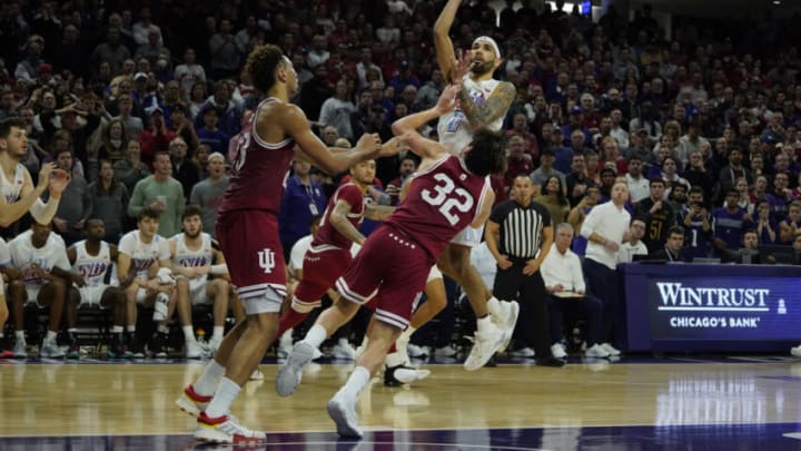 Feb 15, 2023; Evanston, Illinois, USA; Northwestern Wildcats guard Boo Buie (0) shoots the game winning basket over Indiana Hoosiers guard Trey Galloway (32) during the second half at Welsh-Ryan Arena. Mandatory Credit: David Banks-USA TODAY Sports
