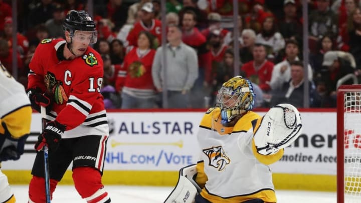 CHICAGO, ILLINOIS - JANUARY 09: Pekka Rinne #35 of the Nashville Predators turns away a shot past Jonathan Toews #19 of the Chicago Blackhawks at the United Center on January 09, 2020 in Chicago, Illinois. (Photo by Jonathan Daniel/Getty Images)