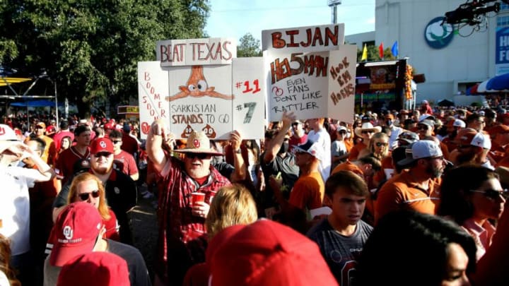 Fans hold signs around the ESPN College GameDay set before the Red River Showdown college football game between the University of Oklahoma Sooners (OU) and the University of Texas (UT) Longhorns at the Cotton Bowl in Dallas, Saturday, Oct. 9, 2021.Ou Vs Texas