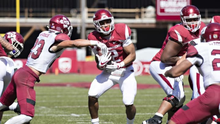 FAYETTEVILLE, AR - SEPTEMBER 30: Chase Hayden #2 of the Arkansas Razorbacks runs the ball up the middle and is hit by Ron LaForce #23 of the New Mexico State Aggies at Donald W. Reynolds Razorback Stadium on September 30, 2017 in Fayetteville, Arkansas. The Razorbacks defeated the Aggies 42-24. (Photo by Wesley Hitt/Getty Images)