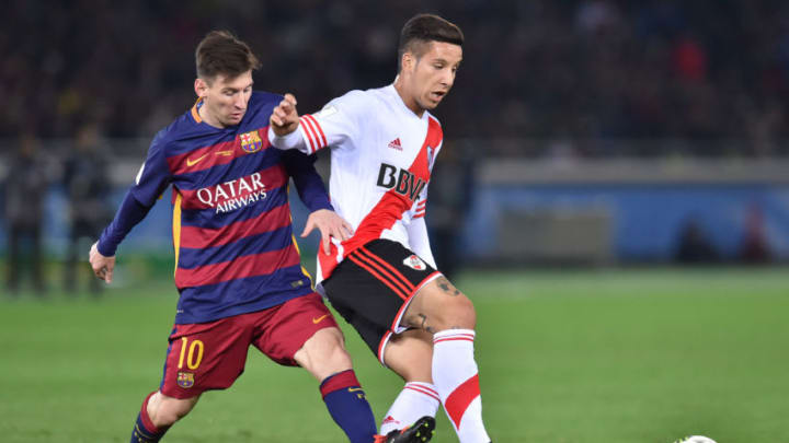 YOKOHAMA, JAPAN - DECEMBER 20: Lionel Messi of FC Barcelona (L) and Sebastian Driussi of River Plate (R) compete for the ball during the final match between River Plate and FC Barcelona at International Stadium Yokohama on December 20, 2015 in Yokohama, Japan. (Photo by Atsushi Tomura/Getty Images)