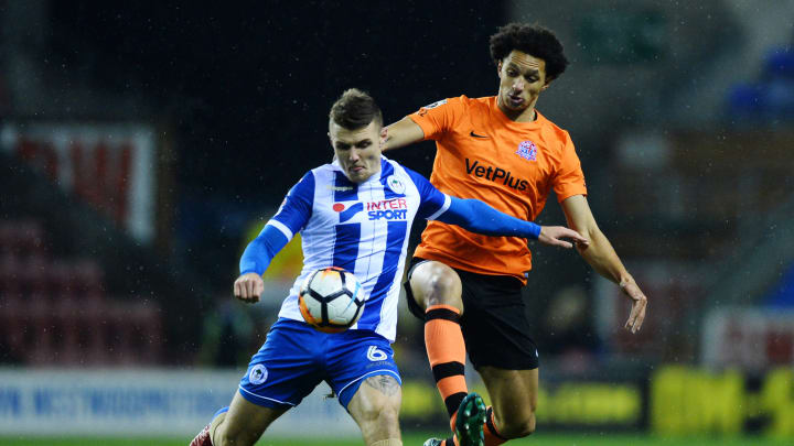 WIGAN, ENGLAND – DECEMBER 12: Lewis Montrose of AFC Fylde and Max Power of Wigan Athletic in action during The Emirates FA Cup Second Round Replay match between Wigan Athletic and AFC Fylde at the DW Stadium on December 12, 2017 in Wigan, England. (Photo by Nathan Stirk/Getty Images)