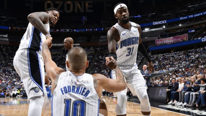 ORLANDO, FL - APRIL 21: Terrence Ross #31 of the Orlando Magic helps Evan Fournier #10 of the Orlando Magic to his feet against the Toronto Raptors during Game Four of Round One of the 2019 NBA Playoffs on April 21, 2019 at Amway Center in Orlando, Florida. NOTE TO USER: User expressly acknowledges and agrees that, by downloading and or using this photograph, User is consenting to the terms and conditions of the Getty Images License Agreement. Mandatory Copyright Notice: Copyright 2019 NBAE (Photo by Fernando Medina/NBAE via Getty Images)