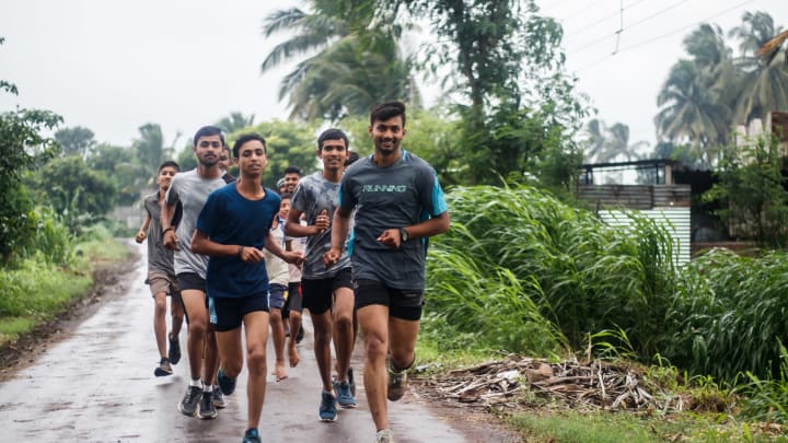 Students of Bajrangbali academy running a patch of seven kilometers as part of their regular training on a concrete road where they must carefully dodge vehicles, especially trucks, tractors, and bullock carts. Photo Credit: Sanket Jain