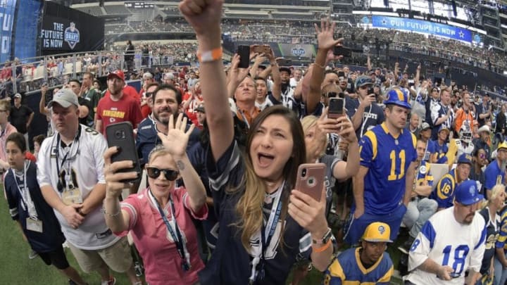 Dallas Cowboys fans celebrate as former Cowboys scout Gil Brandt announces Dorance Armstrong Jr., as the team's fourth-round pick during the final day of the 2018 NFL Draft at AT