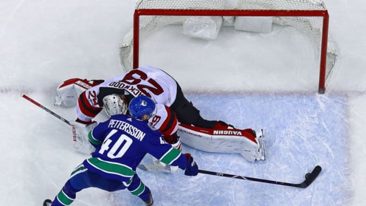 VANCOUVER, BC - MARCH 15: Elias Pettersson #40 of the Vancouver Canucks scores on Mirco Mueller #25 of the New Jersey Devils during their NHL game at Rogers Arena March 15, 2019 in Vancouver, British Columbia, Canada. New Jersey won 3-2. (Photo by Jeff Vinnick/NHLI via Getty Images)
