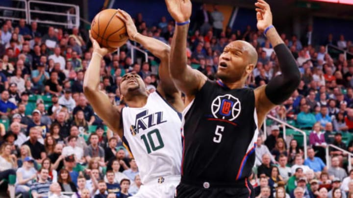 Mar 13, 2017; Salt Lake City, UT, USA; Utah Jazz guard Alec Burks (10) is fouled by LA Clippers center Marreese Speights (5) while shooting the ball during the third quarter at Vivint Smart Home Arena. Utah Jazz won the game 114-108. Mandatory Credit: Chris Nicoll-USA TODAY Sports