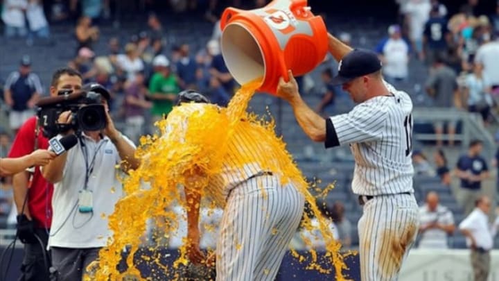 Aug 31, 2013; Bronx, NY, USA; New York Yankees center fielder Brett Gardner (11) dumps a bucket of Gatorade on starting pitcher Ivan Nova (47) after Nova pitched a complete game shutout against the Baltimore Orioles at Yankee Stadium. The Yankees won the game 2-0. Mandatory Credit: Brad Penner-USA TODAY Sports