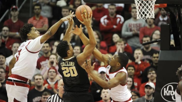 Jan 3, 2016; Louisville, KY, USA; Louisville Cardinals forward Raymond Spalding (13) and guard Donovan Mitchell (45) pressure the shot of Wake Forest Demon Deacons forward John Collins (20) during the second half at KFC Yum! Center. Louisville defeated Wake Forest 65-57. Mandatory Credit: Jamie Rhodes-USA TODAY Sports