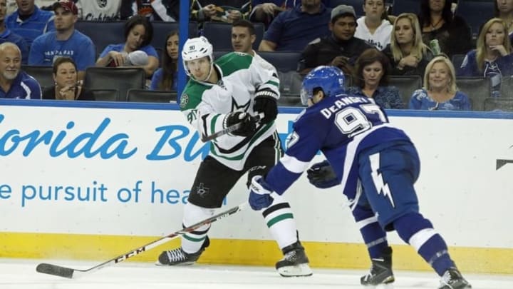 Sep 26, 2014; Tampa, FL, USA; Dallas Stars center Jason Spezza (90) passes the puck as Tampa Bay Lightning defenseman Anthony DeAngelo (97) defends during the third period at Amalie Arena. Tampa Bay Lightning defeated the Dallas Stars 6-3. Mandatory Credit: Kim Klement-USA TODAY Sports