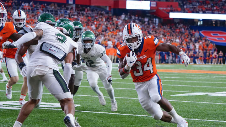 Oct 1, 2022; Syracuse, New York, USA; Syracuse Orange running back Sean Tucker (34) runs with the ball with Wagner Seahawks defensive back Branden Coleman (3) defending during the first half at JMA Wireless Dome. Mandatory Credit: Gregory Fisher-USA TODAY Sports