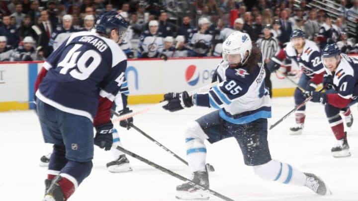 DENVER, CO - APRIL 4: Mathieu Perreault #85 of the Winnipeg Jets takes a shot next to Samuel Girard #49 of the Colorado Avalanche at the Pepsi Center on April 4, 2019 in Denver, Colorado. (Photo by Michael Martin/NHLI via Getty Images)