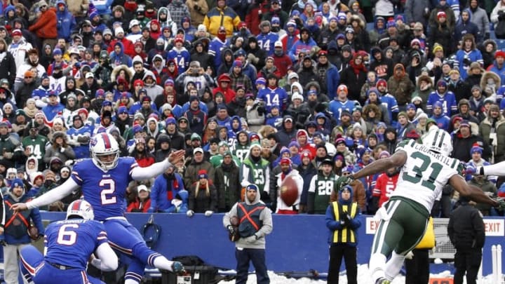 Jan 3, 2016; Orchard Park, NY, USA; Buffalo Bills kicker Dan Carpenter (2) kicks a field goal as punter Colton Schmidt (6) holds and New York Jets cornerback Antonio Cromartie (31) rushes during the first half at Ralph Wilson Stadium. Mandatory Credit: Kevin Hoffman-USA TODAY Sports