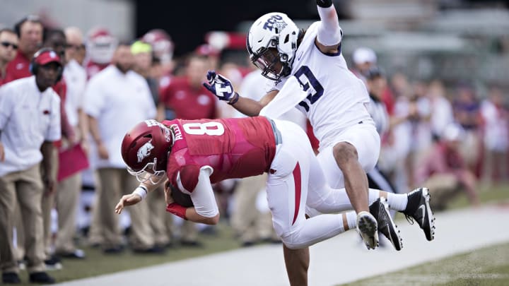 FAYETTEVILLE, AR – SEPTEMBER 9: Nick Orr #18 of the TCU Horned Frogs knocks Austin Allen #8 of the Arkansas Razorbacks out of bounds at Donald W. Reynolds Razorback Stadium on September 9, 2017 in Fayetteville, Arkansas. The Horn Frogs defeated the Razorbacks 28-7. (Photo by Wesley Hitt/Getty Images)
