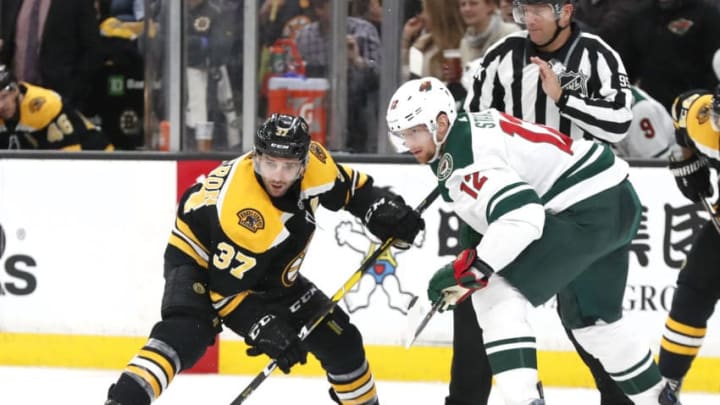 BOSTON, MA - JANUARY 08: Boston Bruins center Patrice Bergeron (37) beats Minnesota Wild center Eric Staal (12) on the draw during a game between the Boston Bruins and the Minnesota Wild on January 8, 2019, at TD Garden in Boston, Massachusetts. (Photo by Fred Kfoury III/Icon Sportswire via Getty Images)